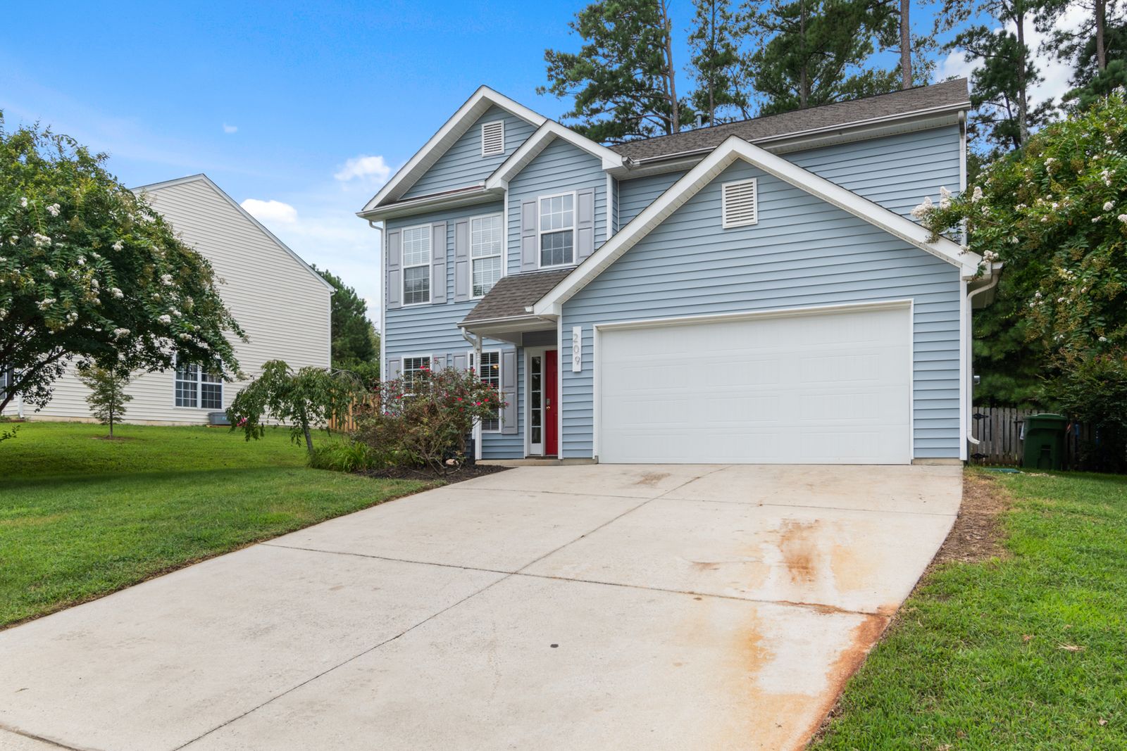 Suburban two-story American home with attached garage, representing coverage under America's Preferred Home Warranty