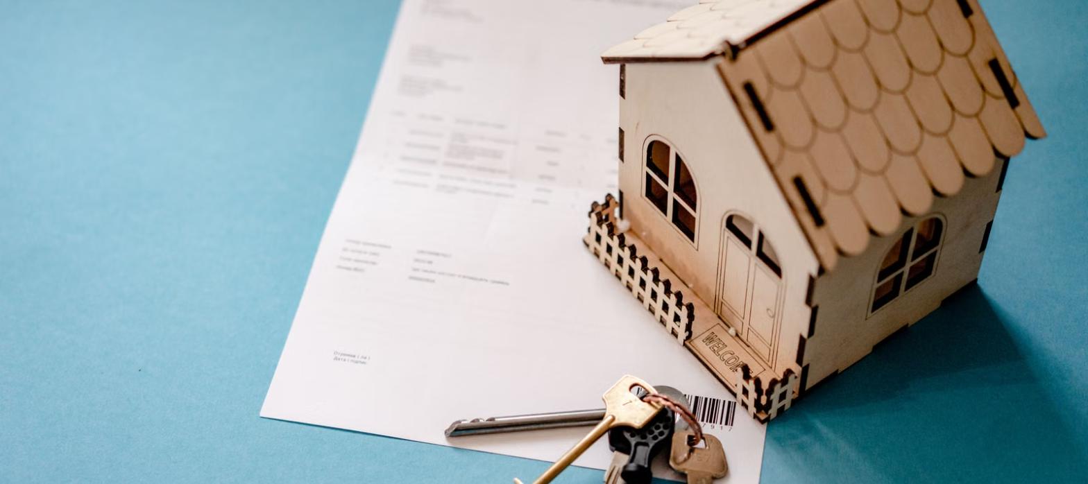 Small house model with keys and a warranty contract, representing a Choice Home Warranty review