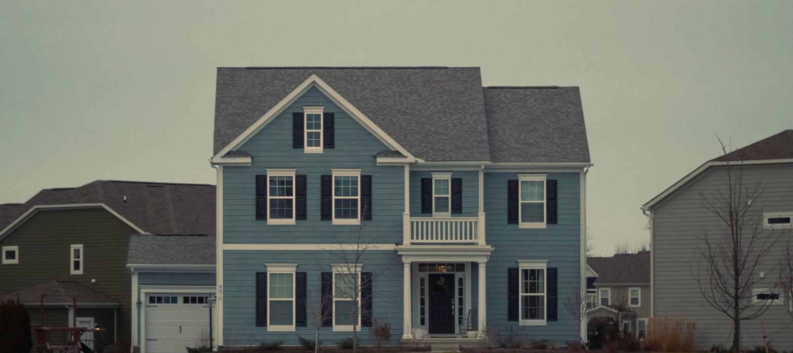 Suburban two-story house exterior representing homes covered by the best home warranty companies