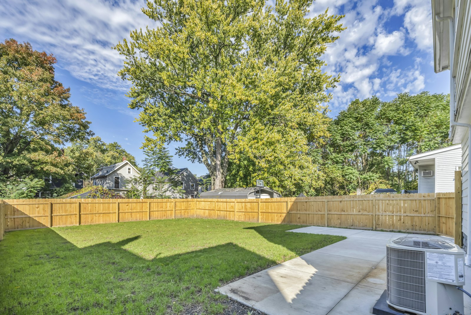 2-10 Home Buyers Warranty reviews: central air conditioning condenser unit beside the patio of a single-family home