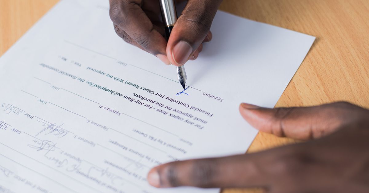 Person signing a form to cancel a home warranty