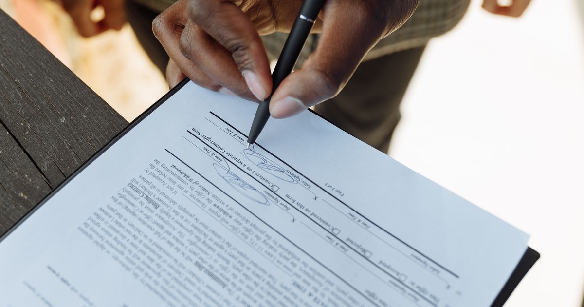 Cinch Home Services review: person signing a home service agreement