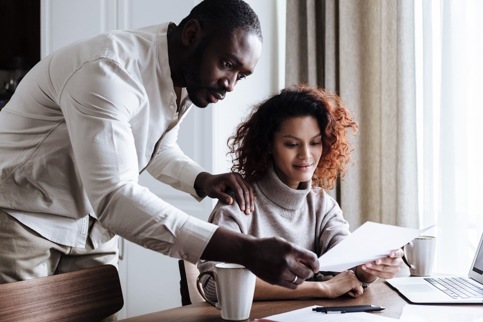 Choice vs Select home warranty comparison: couple reviewing contract documents together at home