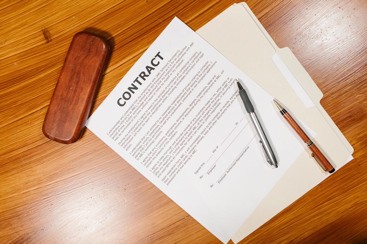 Highlighting clauses on a home warranty contract with a yellow marker